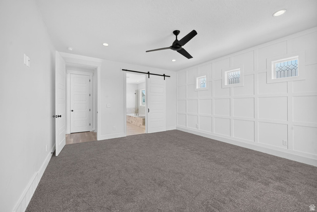 1002 West Temple Rim Lane Payson, UT 84651 - Photo 27 of 68 Spacious room featuring a decorative accent wall with three transom windows, a contemporary ceiling fan, recessed lighting, and soft grey carpeting