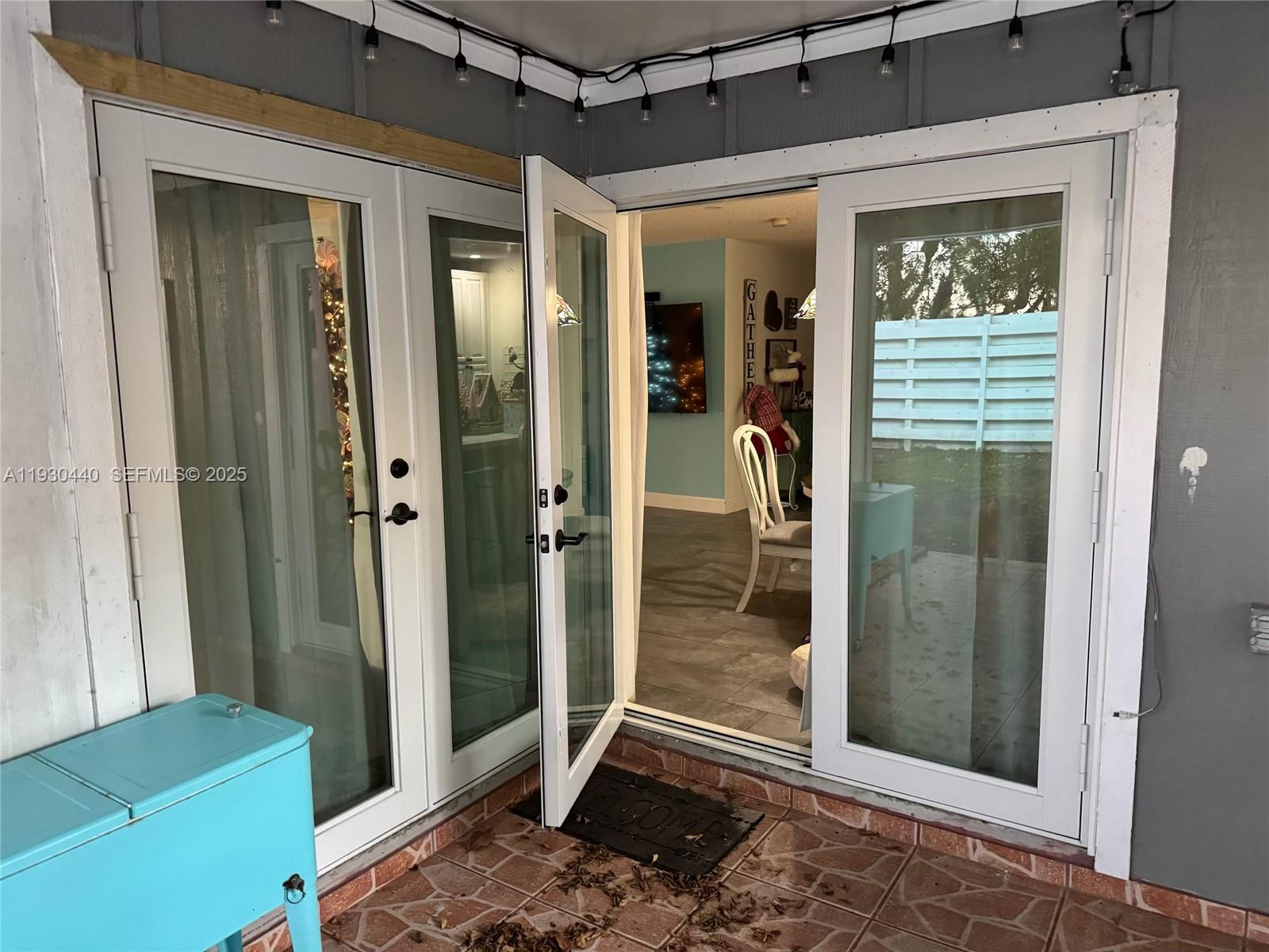 15120 Southwest 141st Place Miami, FL 33186 - Photo 12 of 13 a view of a hallway with a glass door and a bathroom