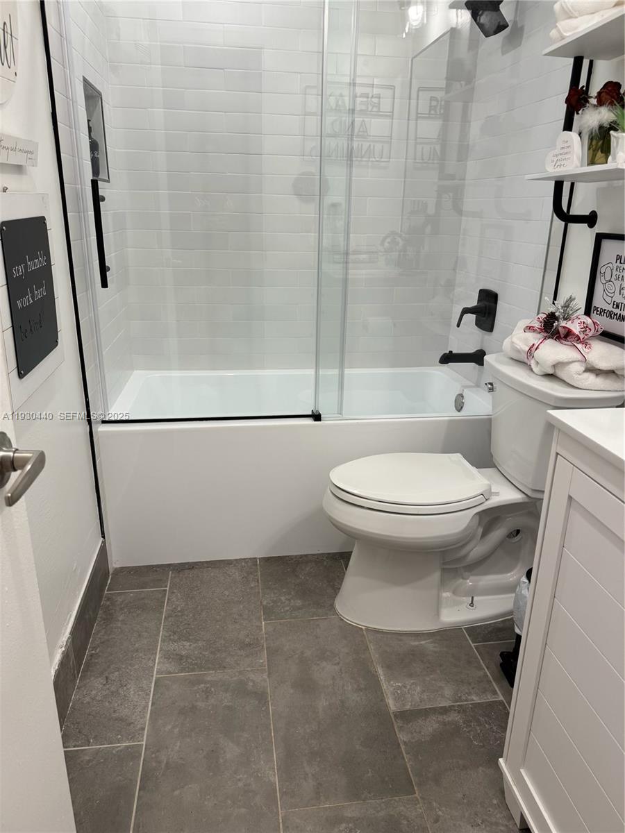 15120 Southwest 141st Place Miami, FL 33186 - Photo 7 of 13 a bathroom with a toilet and a shower