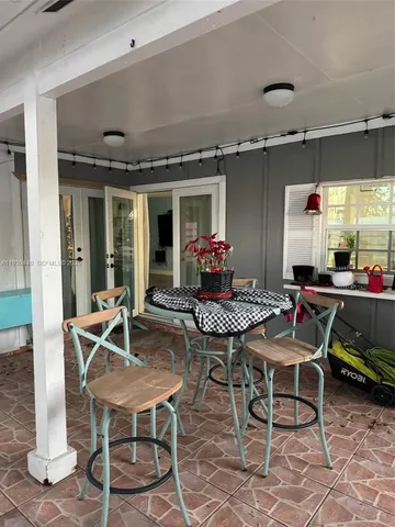 a patio with a table and chairs