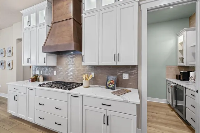 a kitchen with white cabinets and appliances