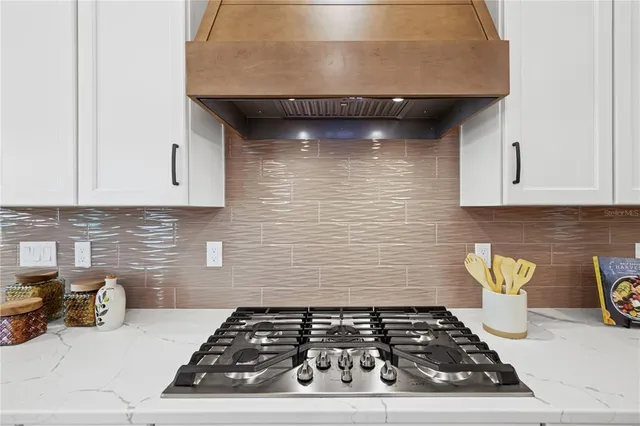 a kitchen with a stove and cabinets