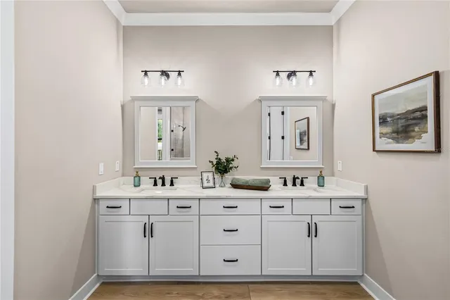 a bathroom with a double vanity sink mirror and