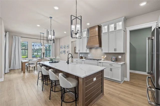 a kitchen with a sink stove and wooden floor