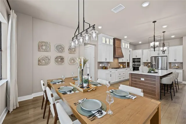a dinning room and kitchen with a table chairs