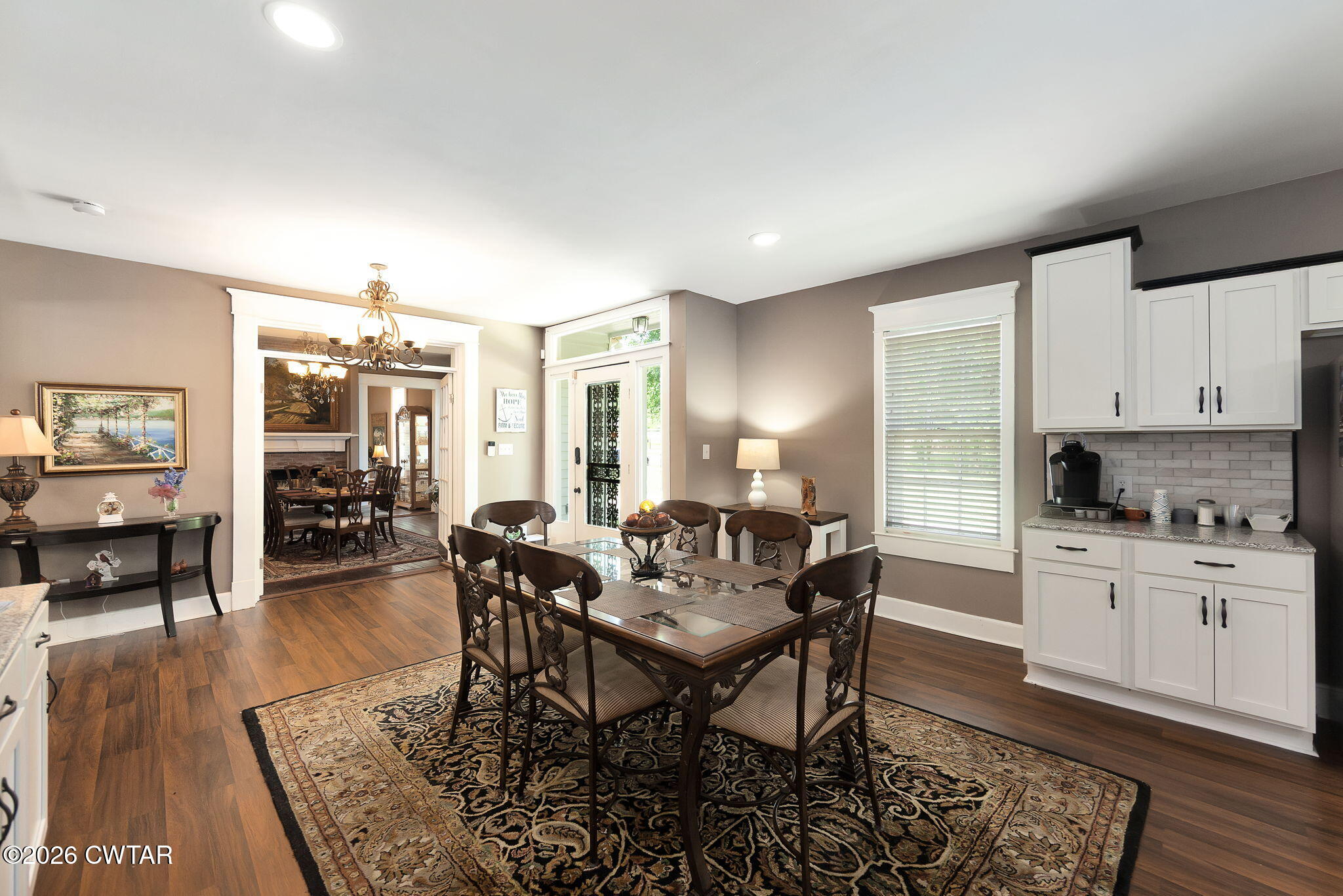 554 East Main Street Jackson, TN 38301 - Photo 16 of 60 a kitchen with stainless steel appliances granite countertop a table and chairs in it