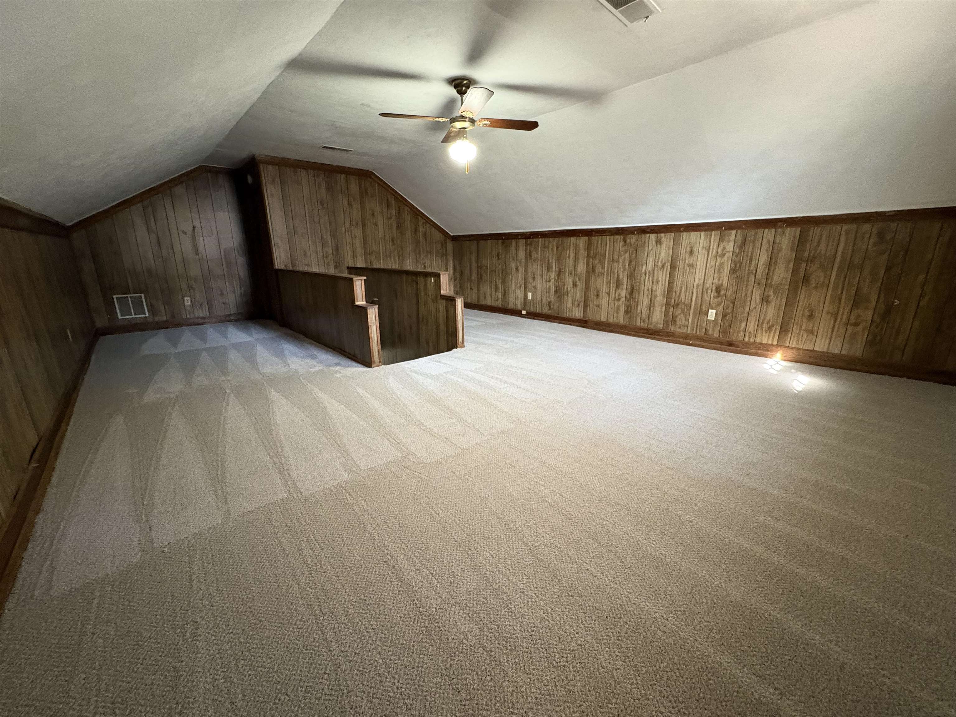 6985 Fords Station Road, Unit 41 Germantown, TN 38138 - Photo 17 of 20 Bonus room featuring wooden walls, light carpet, vaulted ceiling, and a ceiling fan