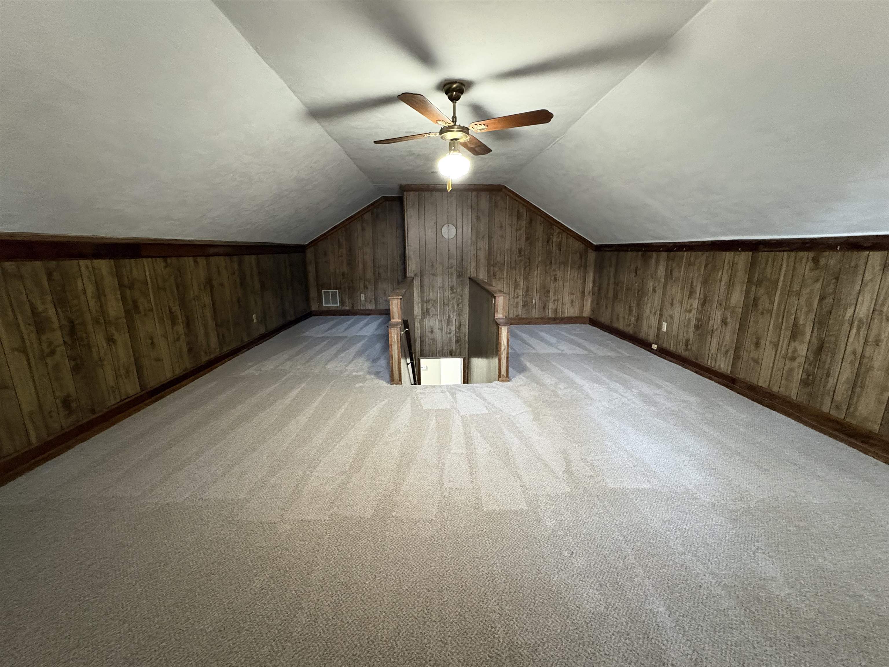 6985 Fords Station Road, Unit 41 Germantown, TN 38138 - Photo 19 of 20 Additional living space featuring wooden walls, light carpet, and ceiling fan