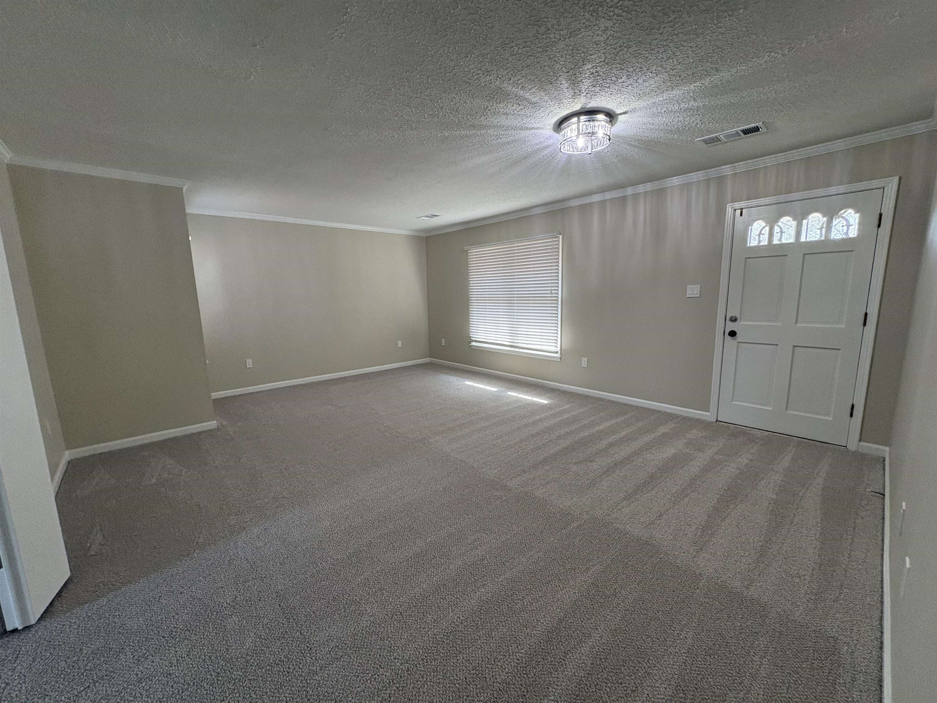 6985 Fords Station Road, Unit 41 Germantown, TN 38138 - Photo 6 of 20 Entryway featuring carpet floors, crown molding, healthy amount of natural light, and a textured ceiling