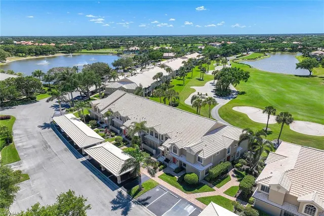 an aerial view of a house with outdoor space and lake view in back