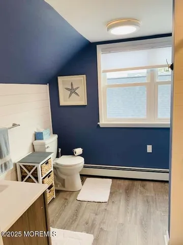 a bathroom with a toilet a sink and mirror