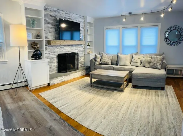 a living room with furniture and a fireplace