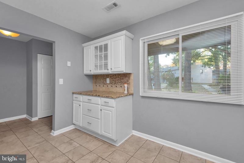 1065 Cedar Ridge Court Annapolis, MD 21403 - Photo 4 of 22 a view of a kitchen with white cabinets and a window