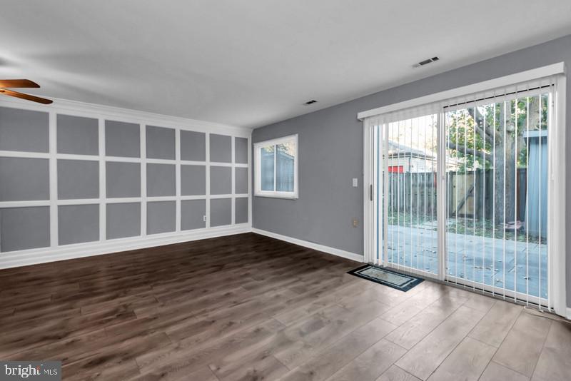 1065 Cedar Ridge Court Annapolis, MD 21403 - Photo 8 of 22 a view of empty room with wooden floor and floor to ceiling window