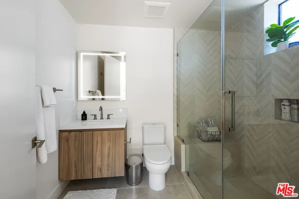 a bathroom with a toilet a sink and tub
