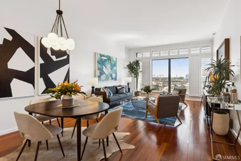 a view of a dining room with furniture window and wooden floor