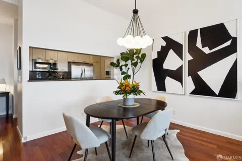 a view of a dining room with furniture and wooden floor