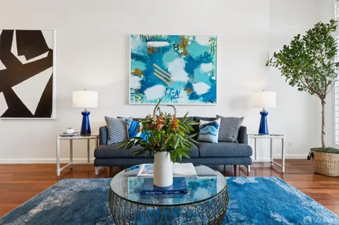 a living room with furniture and a potted plant