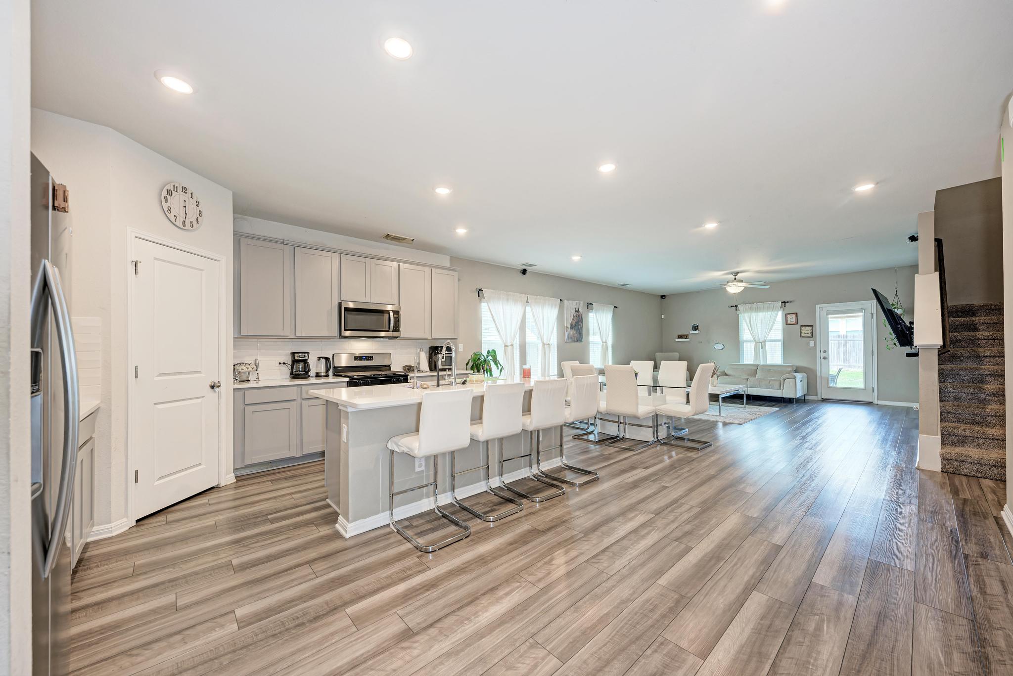 305 Windy Reed Road Hutto, TX 78634 - Photo 5 of 35 Recessed lighting illuminates an open layout featuring seamless transition from cooking to dining areas.