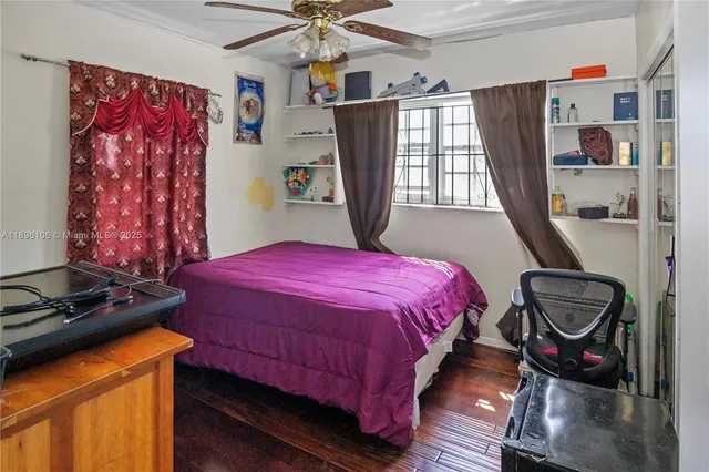 a bed sitting in a bedroom next to a window