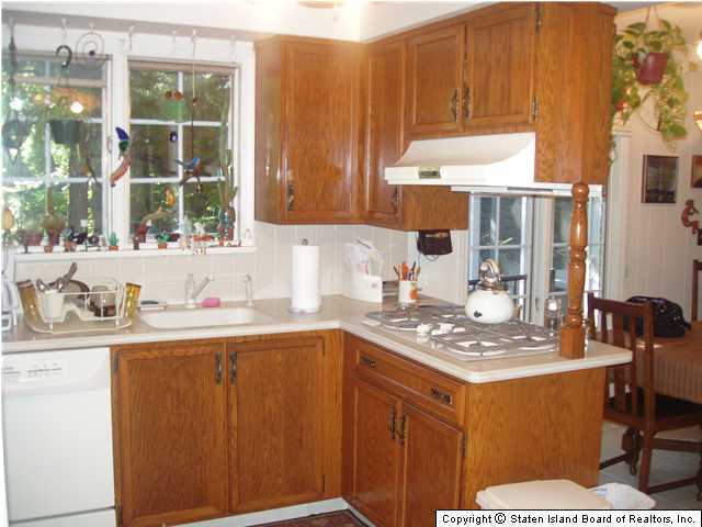 275 Douglas Road Staten Island, NY 10304 - Photo 6 of 11 a kitchen with stainless steel appliances a sink stove and a window