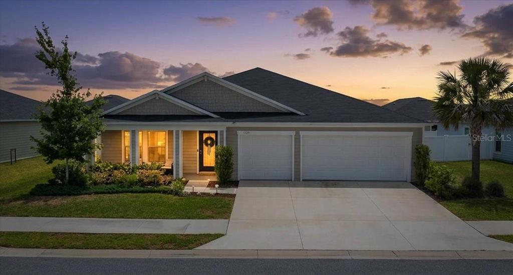 9329 Southwest 57th Terrace Ocala, FL 34476 - Photo 2 of 64 a front view of a house with a yard
