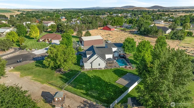 an aerial view of residential houses with outdoor space and street view