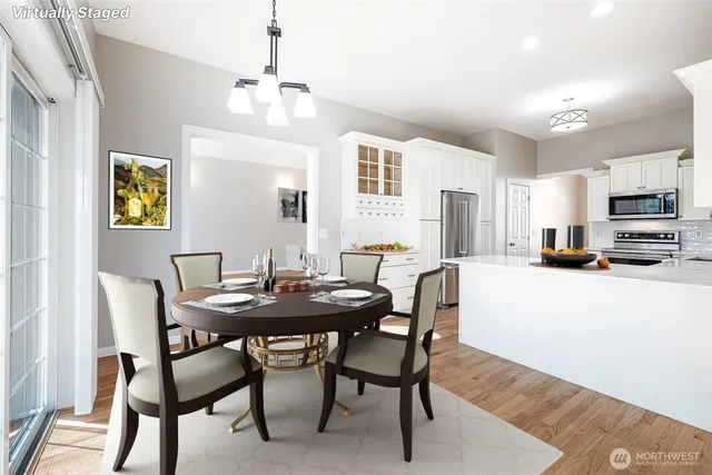 a view of a dining room with furniture and a chandelier