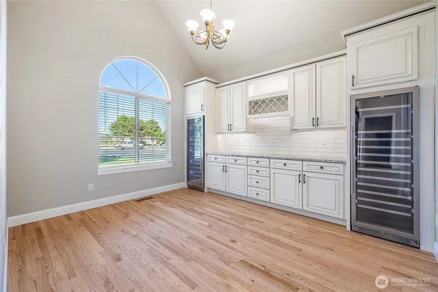 a kitchen with stainless steel appliances granite countertop a stove a sink and a wooden floors