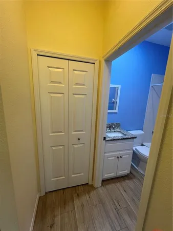 a bathroom with a toilet a sink and mirror