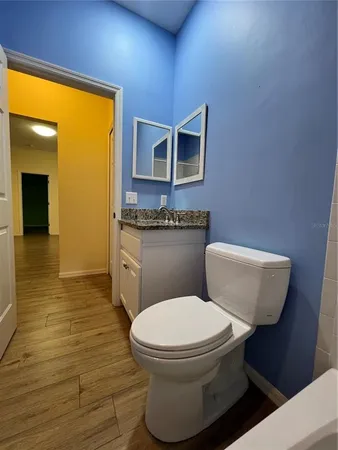 a view of a room with wooden floor