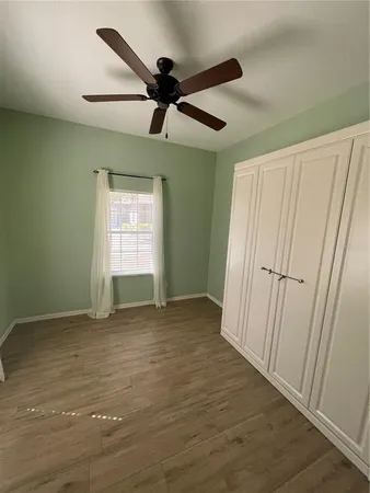 a bedroom with a bed and cabinets