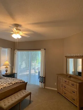 a bathroom with a granite countertop sink a toilet and a mirror