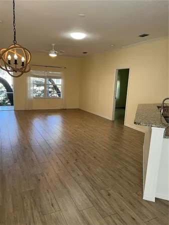 a view of counter top space with granite countertop wooden floor