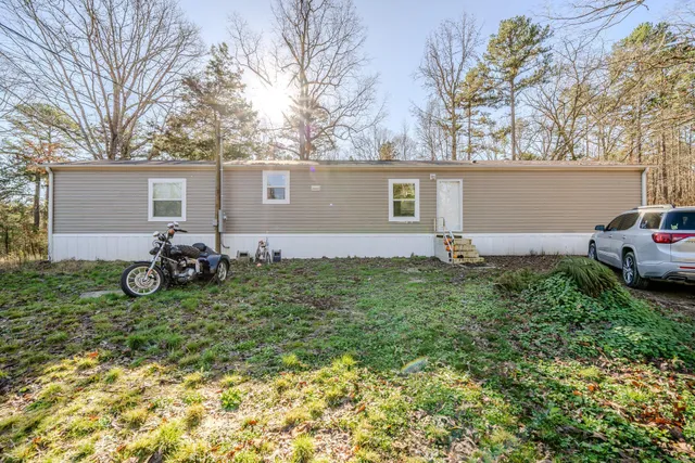 a backyard of a house with yard and outdoor seating