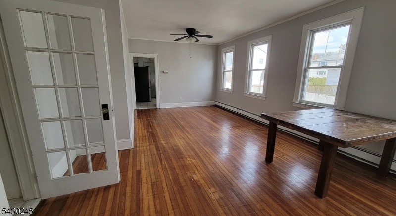39 Alden Street, Unit 1 Wallington, NJ 07057 - Photo 1 of 6 wooden floor in an empty room with a window