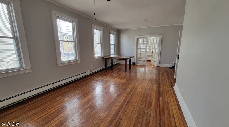 39 Alden Street, Unit 1 Wallington, NJ 07057 - Photo 2 of 6 wooden floor in an empty room with a window