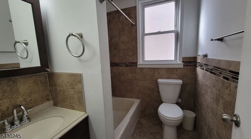 39 Alden Street, Unit 1 Wallington, NJ 07057 - Photo 3 of 6 a bathroom with a sink toilet and shower