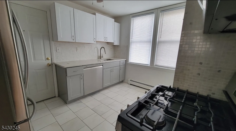 39 Alden Street, Unit 1 Wallington, NJ 07057 - Photo 4 of 6 a kitchen with a stove and a refrigerator