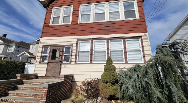 39 Alden Street, Unit 1 Wallington, NJ 07057 - Photo 6 of 6 a front view of a house with a yard