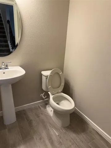 a white toilet sitting next to a bathroom sink