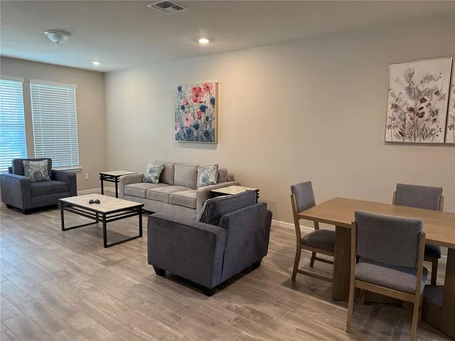 a living room with furniture a rug and a table