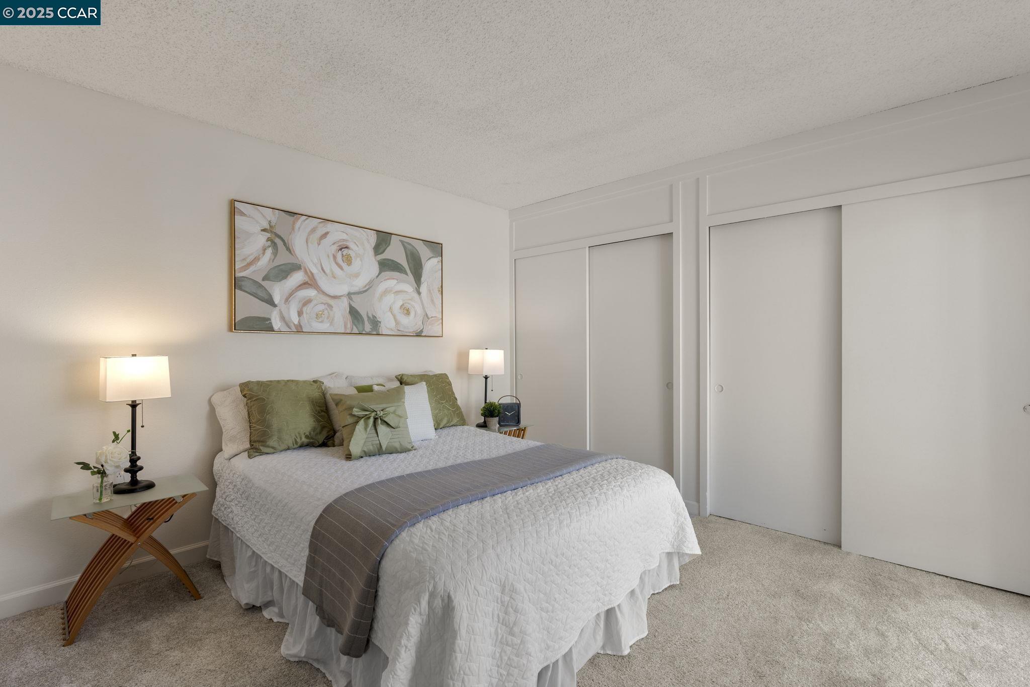 2017 Pine Knoll Drive, Unit 4 Walnut Creek, CA 94595 - Photo 12 of 21 a bedroom with a bed and a lamp on dresser