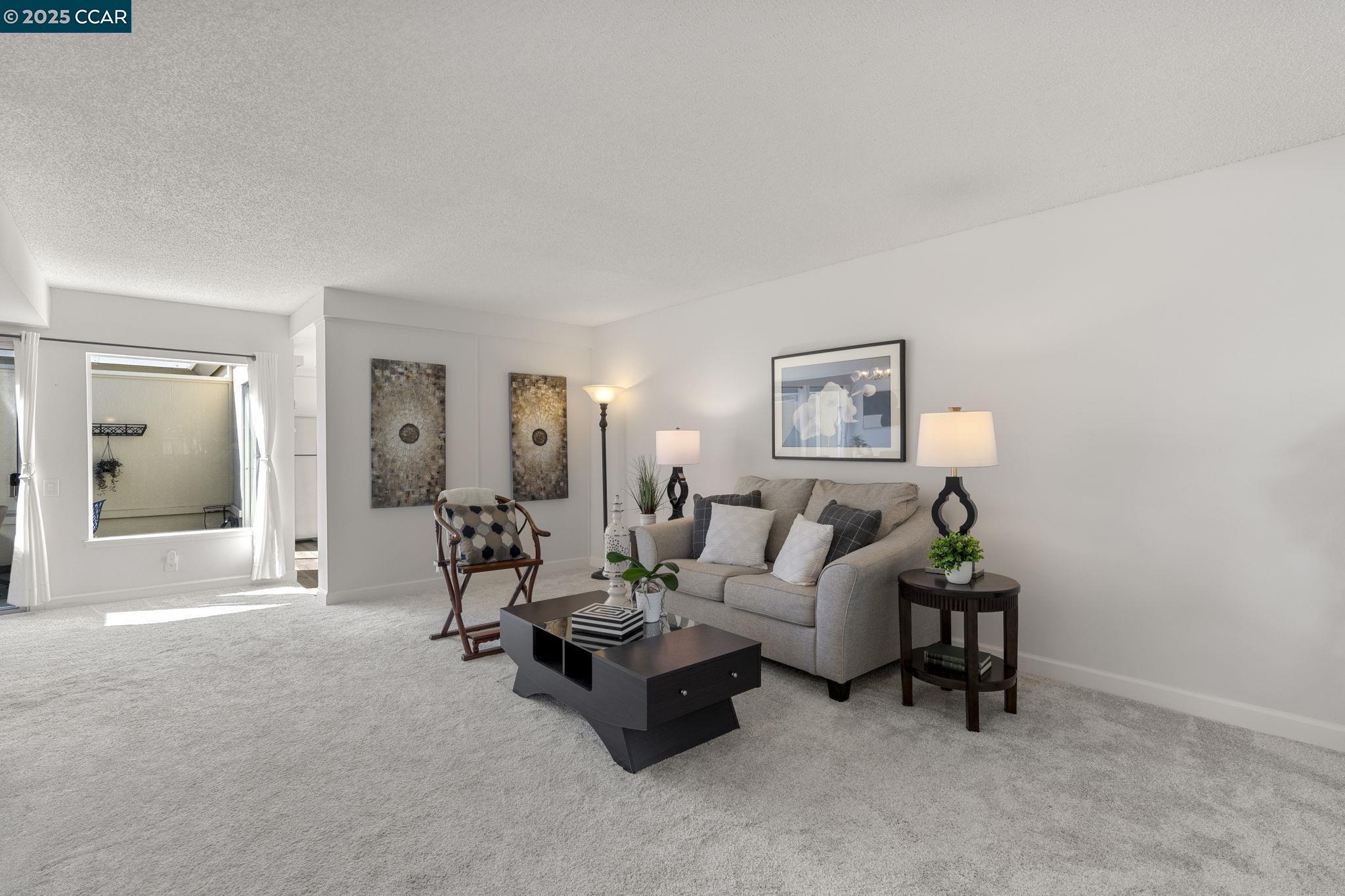 2017 Pine Knoll Drive, Unit 4 Walnut Creek, CA 94595 - Photo 6 of 21 a living room with furniture and a lamp