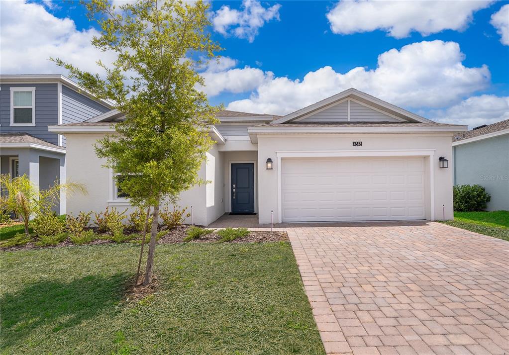 4318 Eastminster Road Davenport, FL 33837 - Photo 1 of 1 a front view of a house with a yard and garage