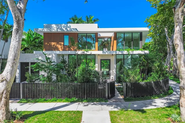 a front view of a house with a garden