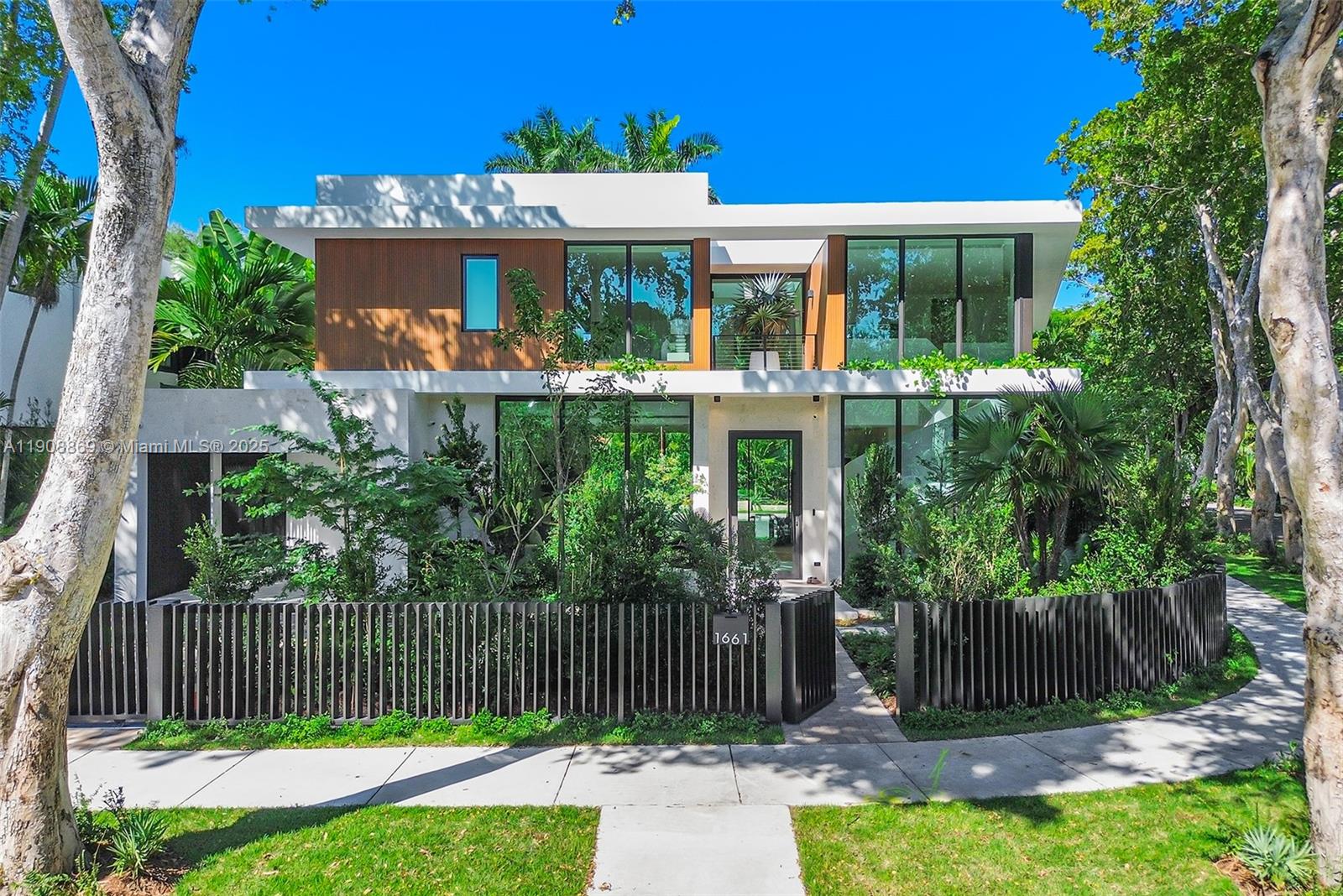 1661 Onaway Drive Miami, FL 33133 - Photo 1 of 26 a front view of a house with a garden