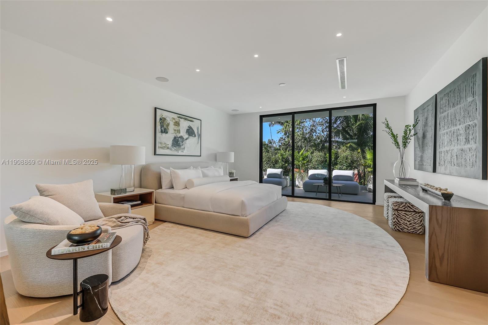 1661 Onaway Drive Miami, FL 33133 - Photo 14 of 26 a spacious bedroom with a large bed and windows