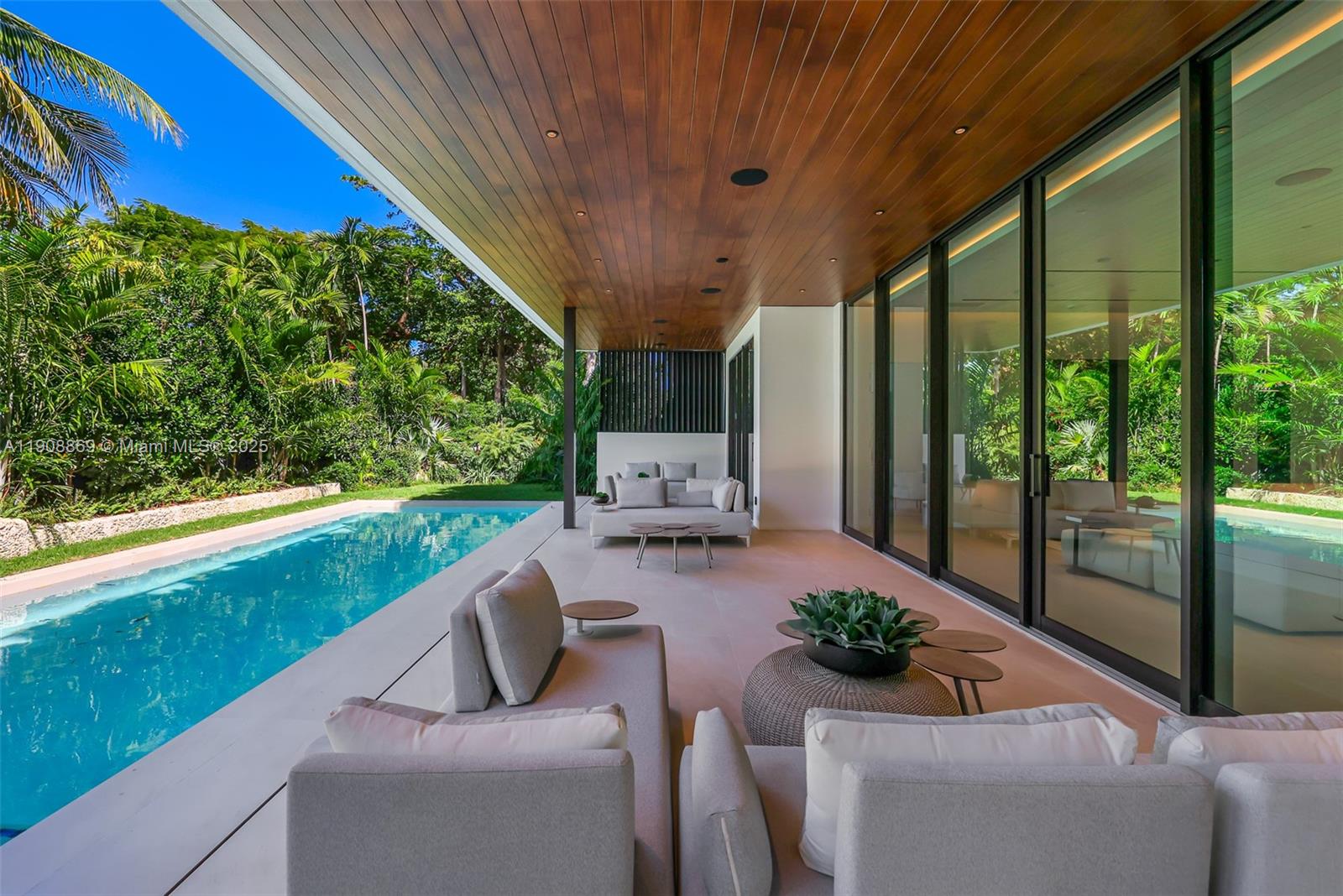 1661 Onaway Drive Miami, FL 33133 - Photo 4 of 26 a view of a patio with couches table and chairs and potted plants