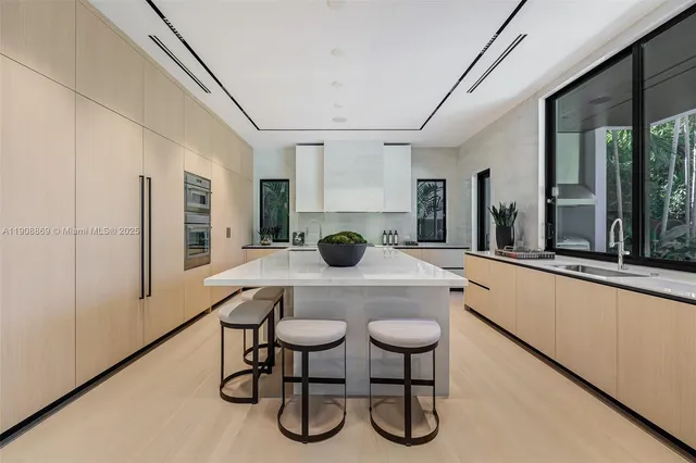 a kitchen with a table chairs cabinets and stainless steel appliances